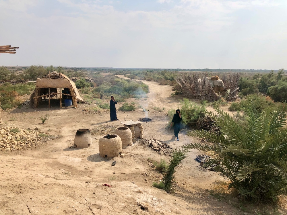An Ahwari family cook Saih bread and grilled fish in the Hawizah marshes in Missan province in an area yet to be appropriated for oil extraction. An Ahwari family cook Saih bread and grilled fish in the Hawizah marshes in Missan province in an area yet to be appropriated for oil extraction.