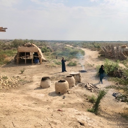 An Ahwari family cook Saih bread and grilled fish in the Hawizah marshes in Missan province in an area yet to be appropriated for oil extraction. An Ahwari family cook Saih bread and grilled fish in the Hawizah marshes in Missan province in an area yet to be appropriated for oil extraction.