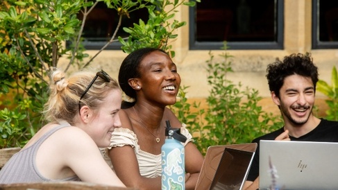 Students smiling in Trinity Hall gardens