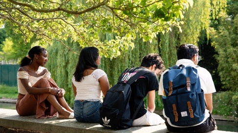 Students on wall at Trinity Hall gardens