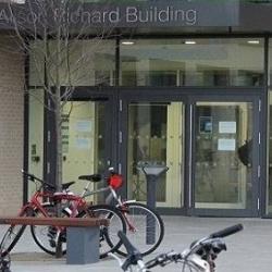 Alison Richard Building front doors with bicycles parked in front.